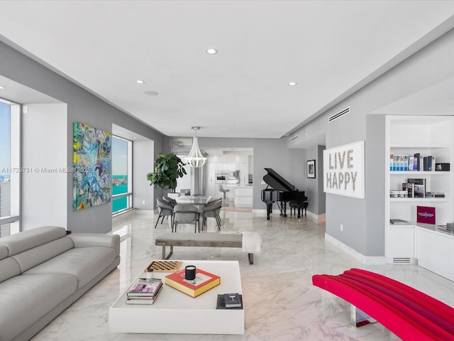 living room with an inviting chandelier and a wealth of natural light