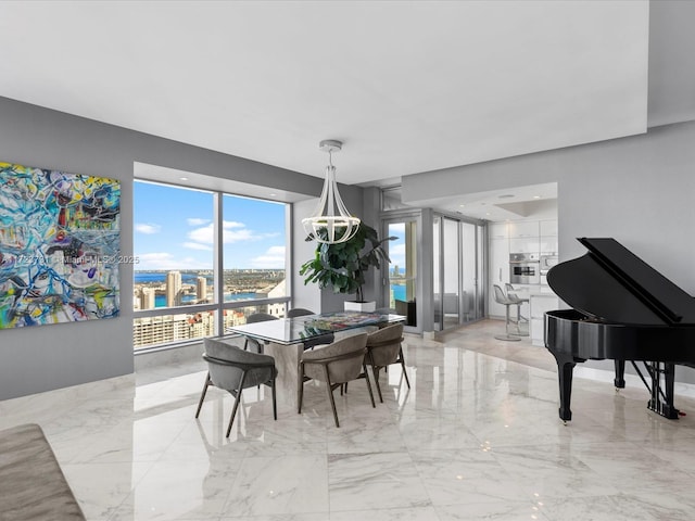 dining area with a notable chandelier and a water view