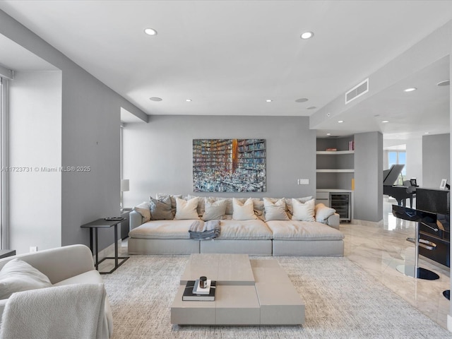 living room with built in shelves and beverage cooler