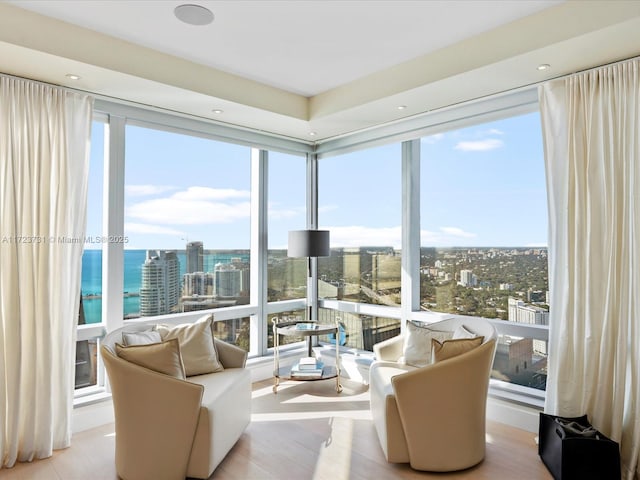 sunroom / solarium featuring a water view