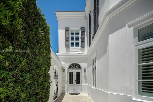 view of exterior entry featuring french doors