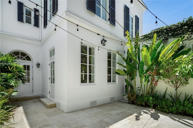 view of side of property with a patio