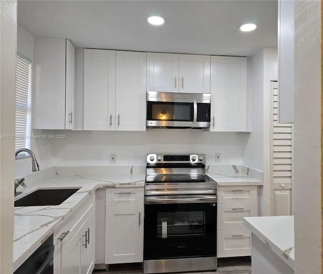 kitchen with white cabinets and appliances with stainless steel finishes