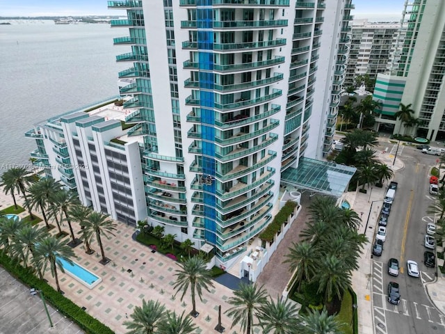 view of building exterior featuring a view of city and a water view