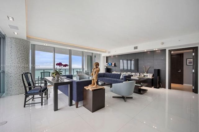 living room with expansive windows, a water view, visible vents, and light tile patterned floors