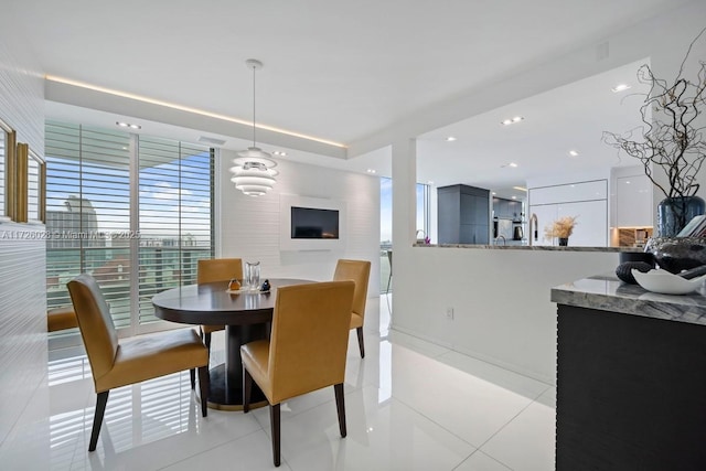 dining area with light tile patterned floors and recessed lighting