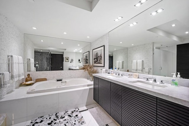 bathroom featuring double vanity, a shower stall, a sink, and recessed lighting