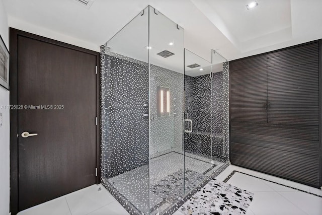 bathroom with a stall shower and tile patterned floors