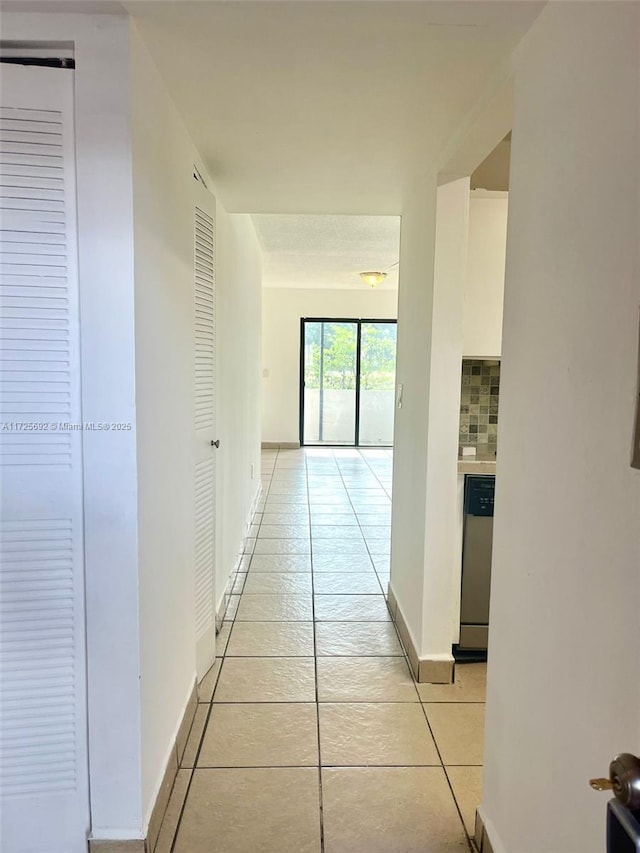 hallway with light tile patterned floors