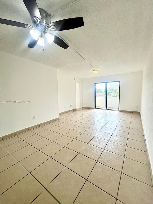 tiled empty room with ceiling fan