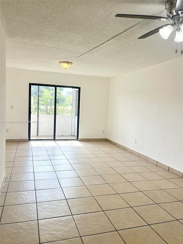 tiled spare room with ceiling fan and a textured ceiling