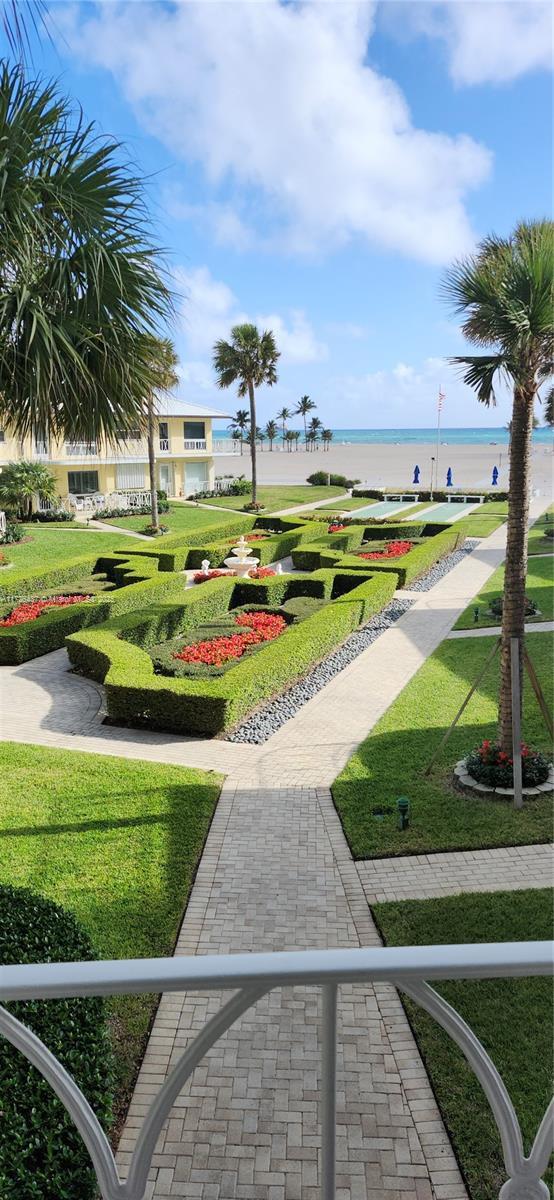 view of home's community featuring a lawn and a water view