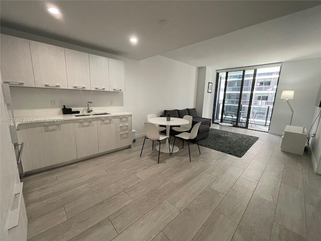 interior space featuring floor to ceiling windows and sink