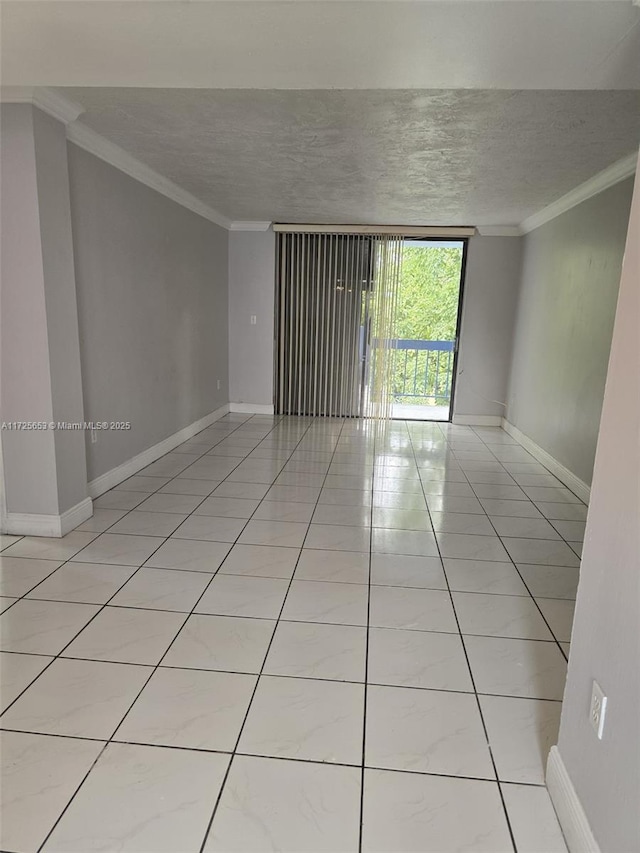 empty room featuring a textured ceiling, light tile patterned flooring, and crown molding