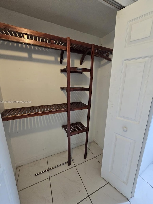 walk in closet featuring tile patterned flooring