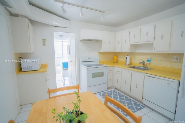 kitchen with tasteful backsplash, sink, white appliances, and white cabinets