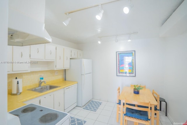 kitchen featuring sink, white appliances, light tile patterned floors, backsplash, and white cabinets