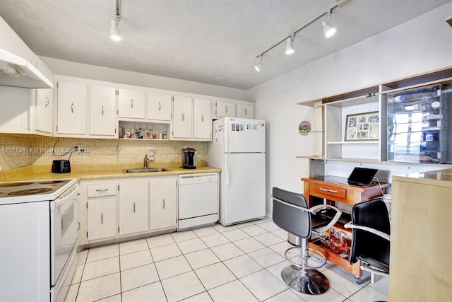 kitchen featuring tasteful backsplash, white cabinetry, sink, light tile patterned floors, and white appliances