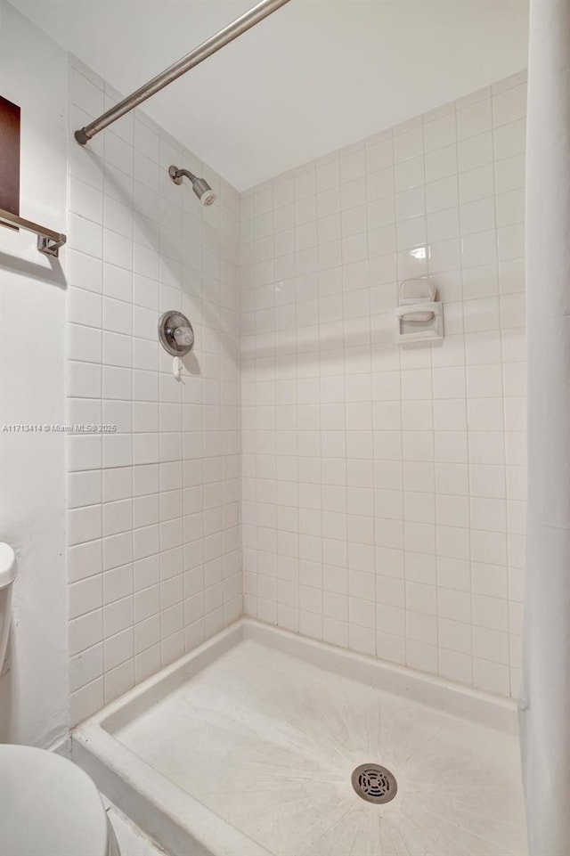 bathroom with tiled shower