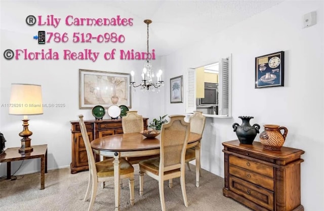 dining area with light colored carpet and an inviting chandelier