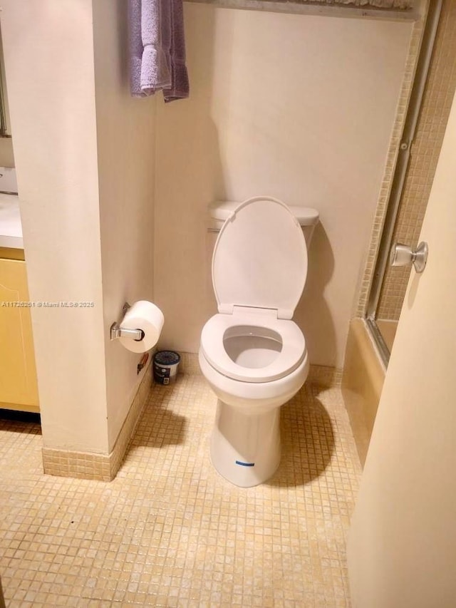 bathroom featuring toilet and tile patterned flooring