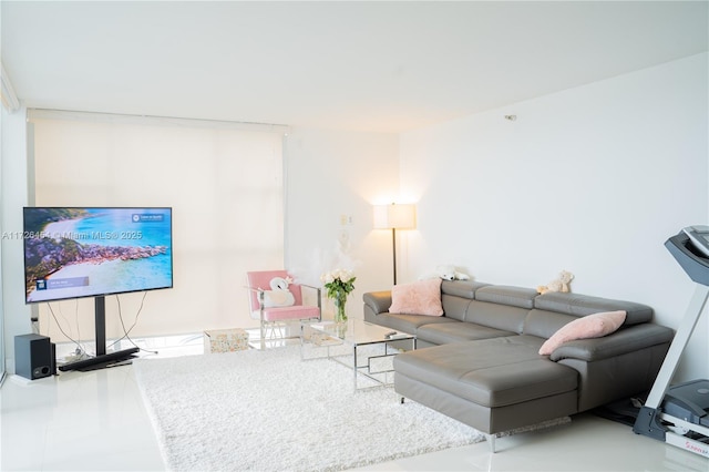 living room featuring floor to ceiling windows, tile patterned flooring, and a healthy amount of sunlight