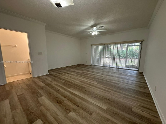 unfurnished room featuring a textured ceiling, ornamental molding, ceiling fan, and dark hardwood / wood-style floors