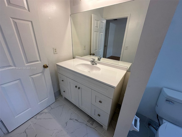 bathroom featuring vanity and toilet