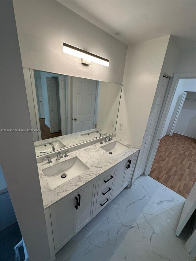 bathroom with vanity, tiled shower, and toilet