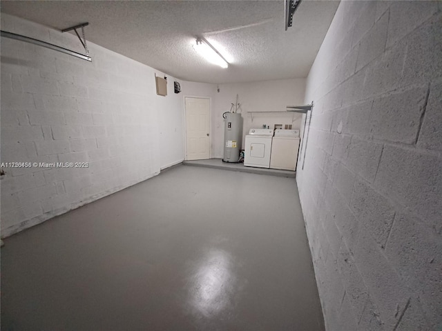 garage featuring water heater and washing machine and clothes dryer