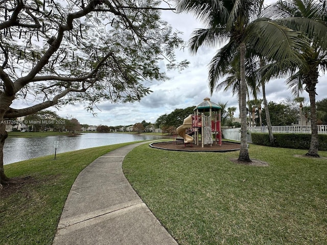 view of property's community featuring a yard, a playground, and a water view