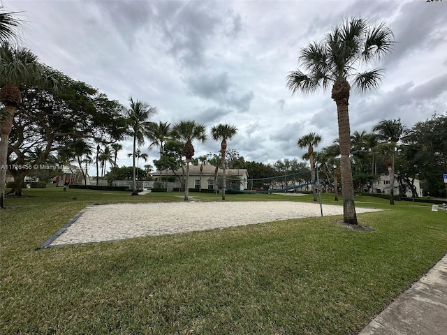 view of home's community featuring a lawn and volleyball court