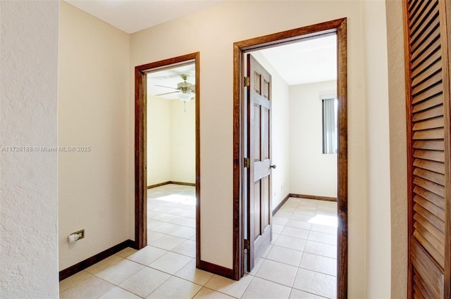 hall featuring light tile patterned floors