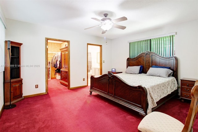 carpeted bedroom featuring a spacious closet, connected bathroom, ceiling fan, and a closet