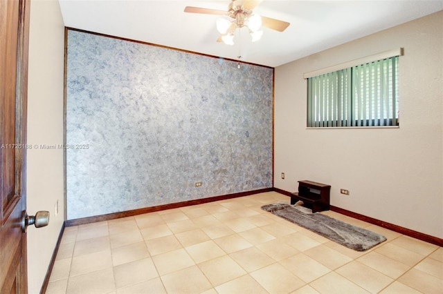 tiled spare room featuring ceiling fan