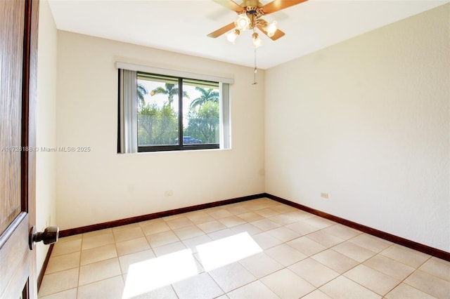 tiled empty room featuring ceiling fan