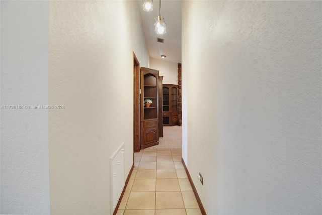 corridor with light tile patterned floors