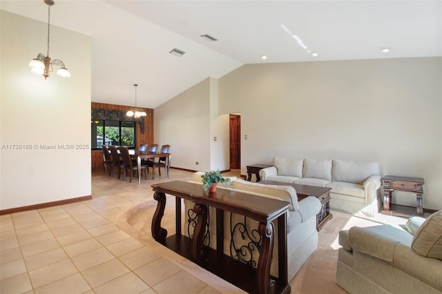 living room with light tile patterned flooring, a chandelier, and vaulted ceiling