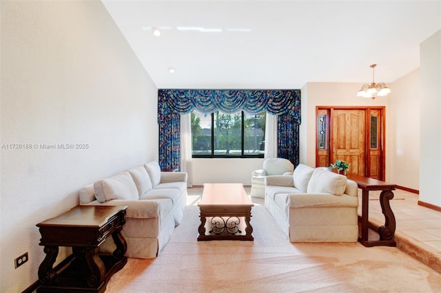 living room featuring lofted ceiling and a notable chandelier