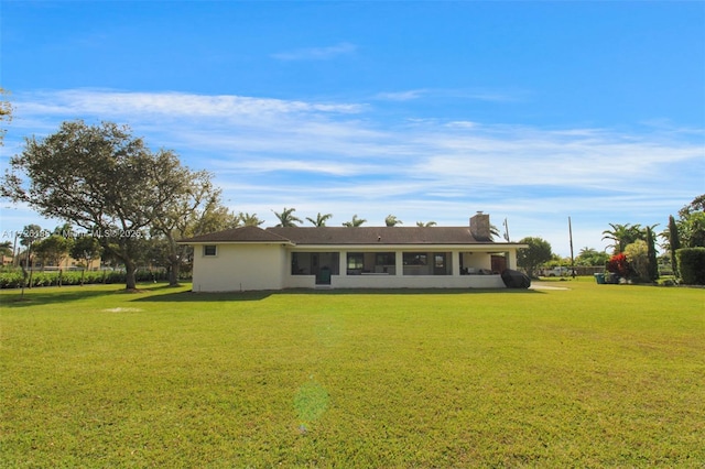 back of property featuring a lawn