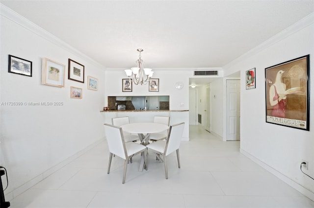 tiled dining room featuring crown molding and a chandelier