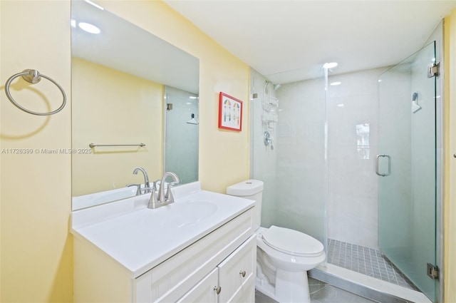 bathroom featuring toilet, tile patterned flooring, walk in shower, and vanity