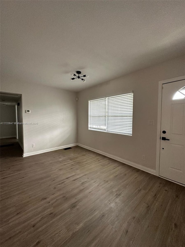 entryway featuring a textured ceiling and dark hardwood / wood-style floors