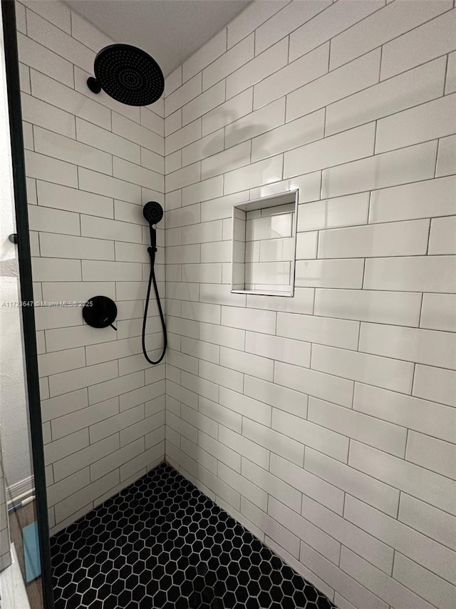 bathroom with a tile shower