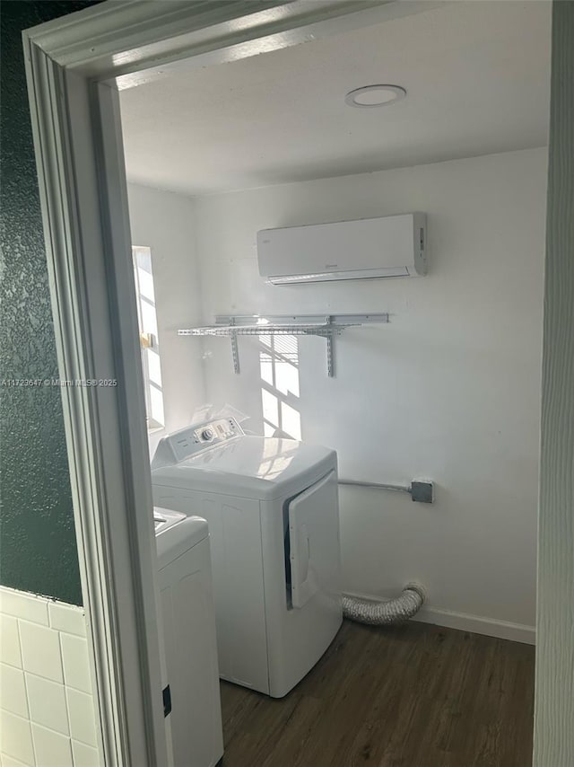 laundry room featuring separate washer and dryer, dark wood-type flooring, and an AC wall unit