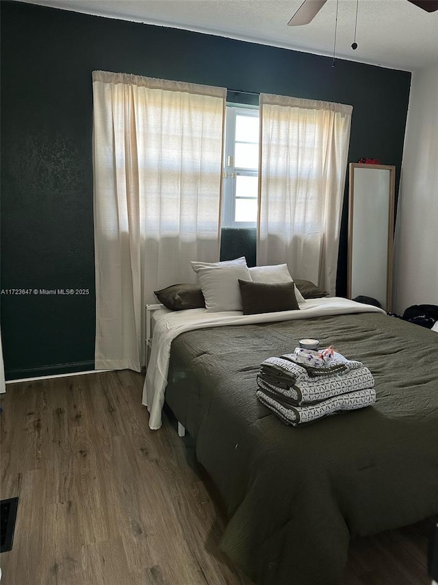 bedroom featuring ceiling fan and hardwood / wood-style flooring