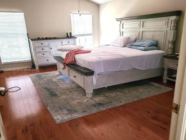 bedroom featuring vaulted ceiling and dark wood-type flooring