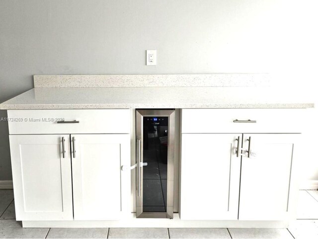 kitchen featuring light tile patterned floors, stainless steel appliances, sink, and white cabinets