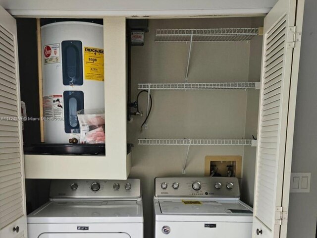 clothes washing area featuring washer and dryer and water heater