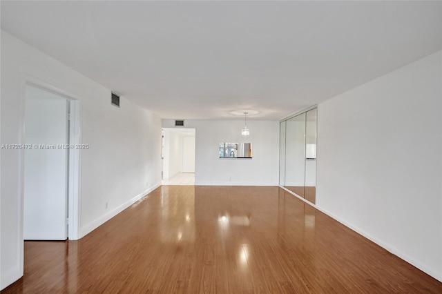 spare room with wood-type flooring